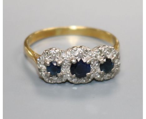 A triple cluster diamond and sapphire ring, 18ct gold shank