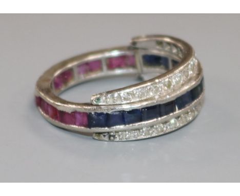 A white metal, diamond, ruby and sapphire swivel triple ring, size M/N.