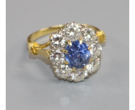 An 18ct gold, sapphire and diamond oval cluster ring, size Q.