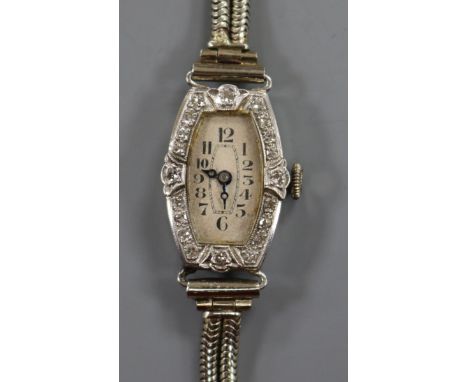 A lady's platinum and diamond set manual wind cocktail watch, on a 9ct white gold twin strand bracelet.