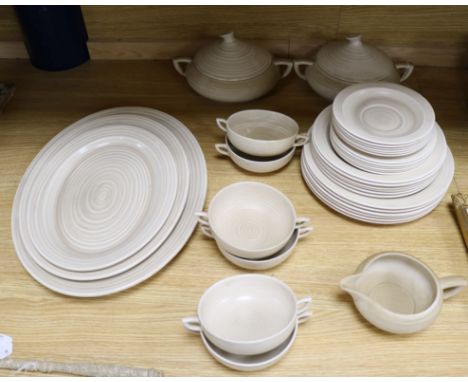 A Clarice Cliff for Wilkinson buff ground pottery dinner service, comprising two tureens and covers with domed covers, a set 