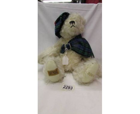 A limited edition Merrythought bear in Tartan hat and Scarf, with growler.