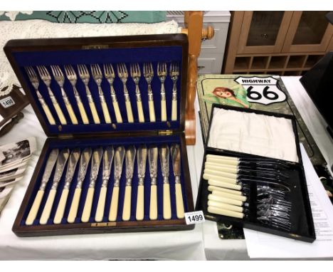 A 1930's oak cased fish knife and fork set and 1 other cutlery set