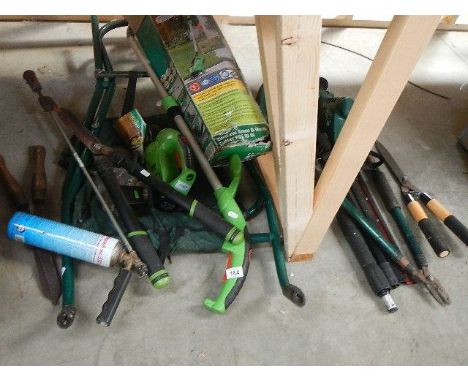 A quantity of electric garden tools and a flat pack wheel barrow.