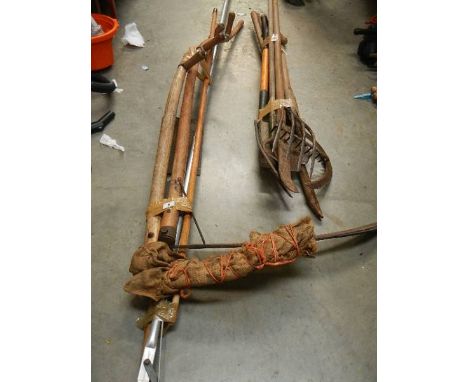 A quantity of garden tools including scythe.