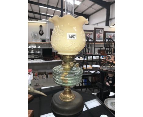 An oil lamp with green tinted font on Bakelite base