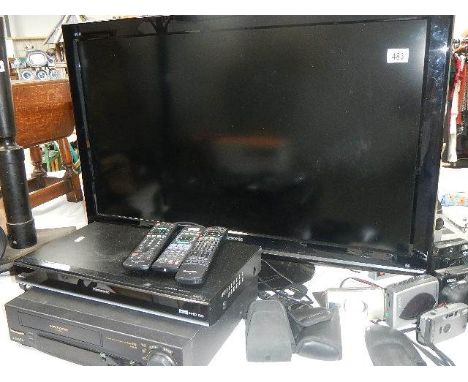 A television, DVD player and video recorder.