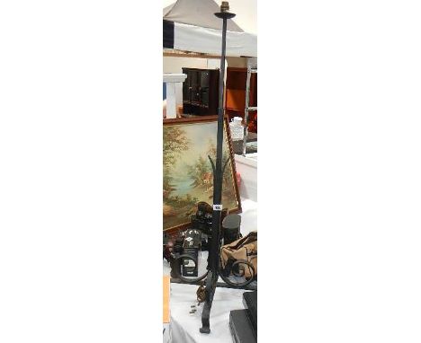 A wrought iron standard lamp base.