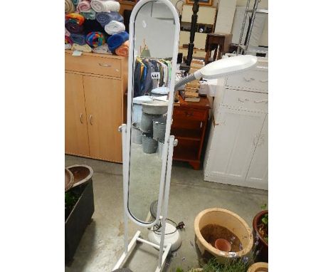 A tall mirror, a floor standing lamp etc.,