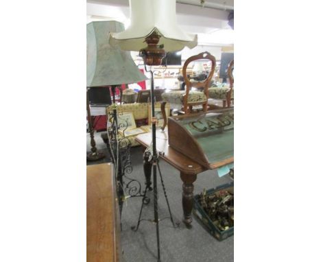 A wrought iron and copper standard lamp with shade.