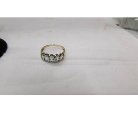 A 9ct gold five stone aquamarine? ring, size O half.