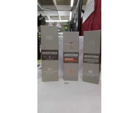 Three bottles of Auchentoshan triple distilled single malt scotch whisky.