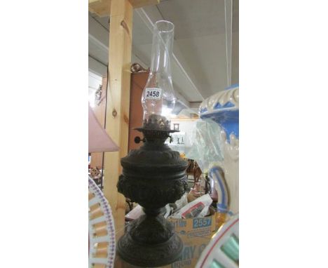 A Victorian oil lamp with chimney.