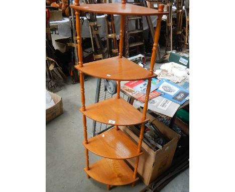 A five shelf oak corner unit.