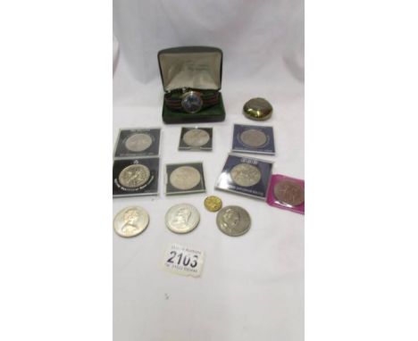 A quantity of commemorative coins, a wrist watch and a snuff box.