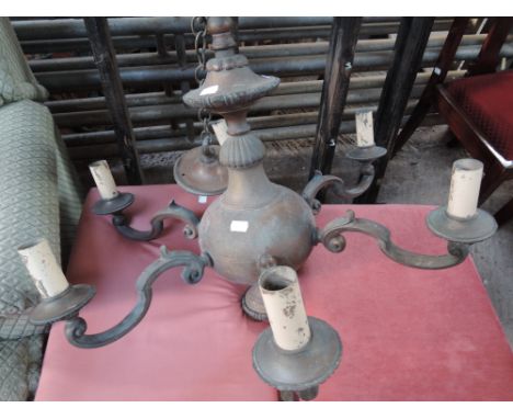 A 6 candle ceiling light fitting in copper and brass effect