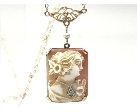 GOLD MOUNTED CAMEO PENDANT, LATE 19TH / EARLY 20TH CENTURY suspended on a gold chain, marked for ten carat gold, set with a d