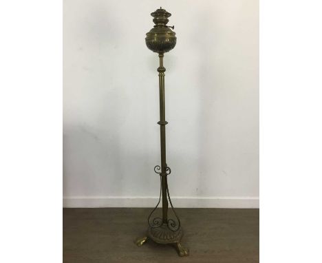 BRASS STANDARD OIL LAMP, with patent burner, on three trefoil feet144cm high