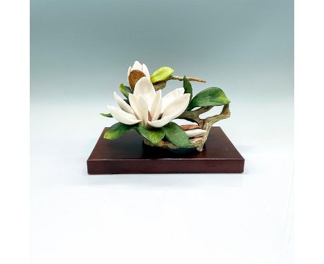 A beautiful naturalistic floral figure of a white blossom and green leaves. Cybis mark on the side. This item has a base incl
