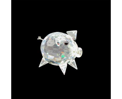 Clear, faceted body has wire corkscrew tail and black button eyes. Swarovski backstamp, 7657 027 000. Artist: Max SchreckIssu
