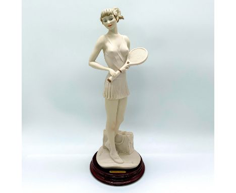 Playful figurine with a young lady holding a tennis racket in her tennis outfit.Gold plaque on the wood base reads: Giuseppe 