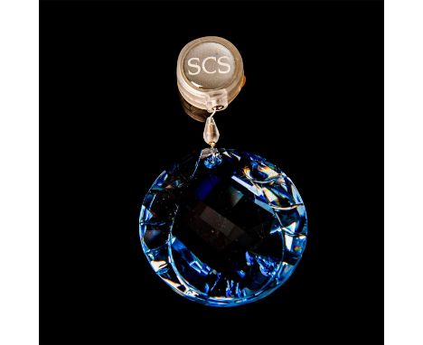 Pale blue crystal with a water droplet relief. Retractable monofilament. Gifted to Swarovski Collectors Society members. Swar