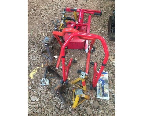 Two motorcycle stands, four pairs of axle stands, a wash tub and an engine stand. 