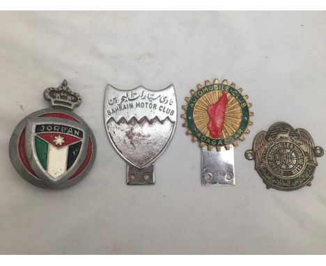 Four assorted Continental car badges including The Automobile Club of Madagascar, Bahrain Motor Club etc.