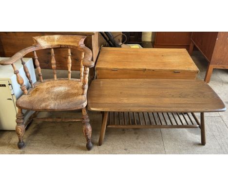 A smokers bow elbow chair together with an Ercol coffee table 