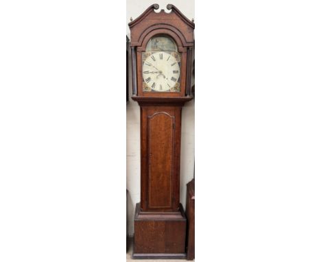 A 19th century oak longcase clock, with an arched pediment above fluted columns and a long trunk door, box base and plinth, t