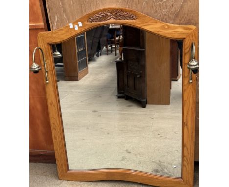 A wall mirror with integral lamp holders 