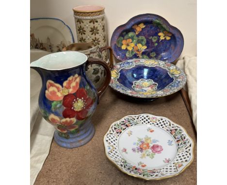 A Royal Doulton pottery jug decorated with flowers and leaves to a blue ground together with a Doulton Lambeth jug, a Royal D