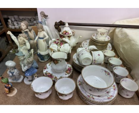 A Royal Albert Old Country Roses pattern part tea service together with a Melba China part tea service, Nao figures, walking 