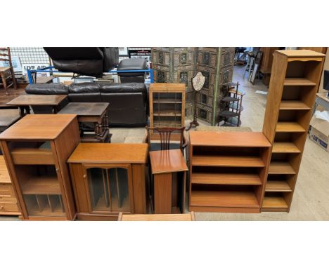 A modern teak HiFi cabinet together with a CD cabinet, two CD revolving cabinets, and two bookcases 