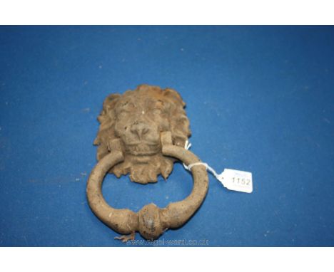 An old cast door knocker with a lion's head.