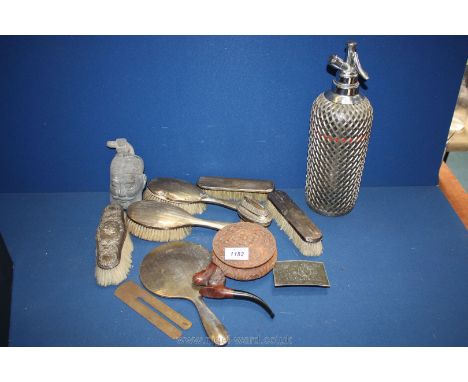 A Ronson lighter, a horse headed pipe, small carved bowl, miscellaneous combs, brushes and mirror and a soda siphon.