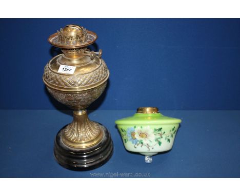 A brass oil lamp and glass bowl.