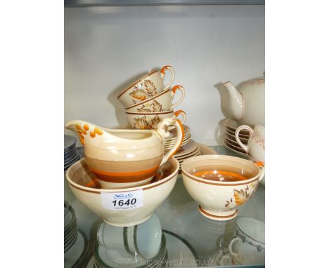 A Myott part Teaset in brown/orange stripe including four cups, five saucers, six side plates, large plate, cream jug and sug
