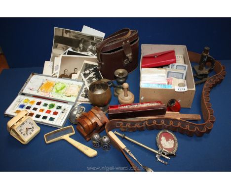 A quantity of miscellanea to include microscope, candlesticks, playing cards, old photographs, pipe, ammunition belt, etc.