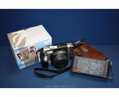 A Kodak 1A pocket camera in a leather case together with a Fuji instant instax wide 300 camera, boxed.