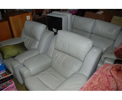 A pale fern green leather upholstered four piece Lounge Suite comprising a three seater settee, a pair of chairs and a pouffe