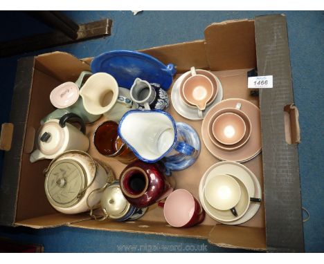 A quantity of Poole china including cups and saucers, jugs, two biscuit barrels etc.