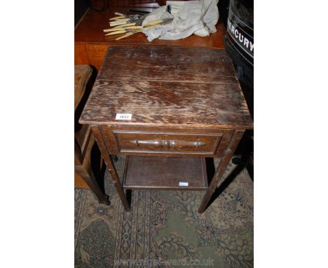 A dark stained Oak workbox table, the hinged lid lifting to reveal a work compartment and having a lower shelf, 17 1/4'' wide