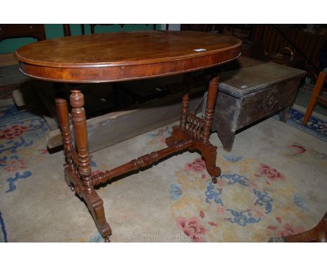 A circa. 1900 Mahogany oval centre Table having bobbin turned details to the turned side supports united by a central turned 