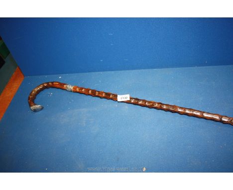 A walking Stick with possibly silver collar and tip to the handle (end damaged).