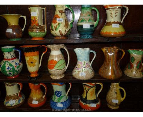 Six colourful Myott Jugs, various patterns including blue and brown jug with pink blossom design, etc.