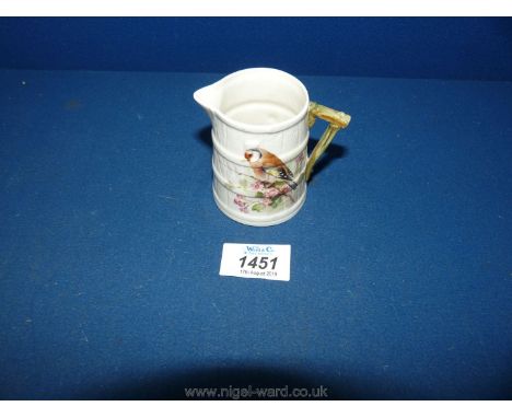 A small Royal Worcester Jug in tapering barrel form, twig handle, finch and blossom decoration.