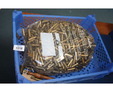 A black powder measure and a quantity of ammunition cases.