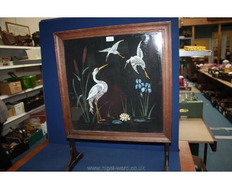 A firescreen with panel under glass of Heron, bulrushes, water lily and iris painted on fabric.