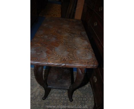 An unusual stained hardwood, rectangular Table, profusely carved with stylised flower blooms, having a lower shelf and standi